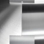 Person polishing stainless steel with microfiber cloth to achieve shine