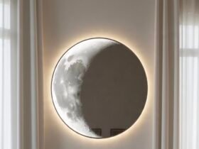 Decorative full moon mirror with textured lunar surface mounted on living room wall