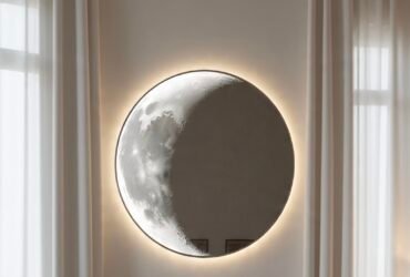 Decorative full moon mirror with textured lunar surface mounted on living room wall